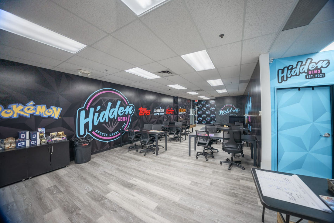 The Hidden Gems Card Shop logo mural above the shop's trading tables in Shelby Township, Michigan